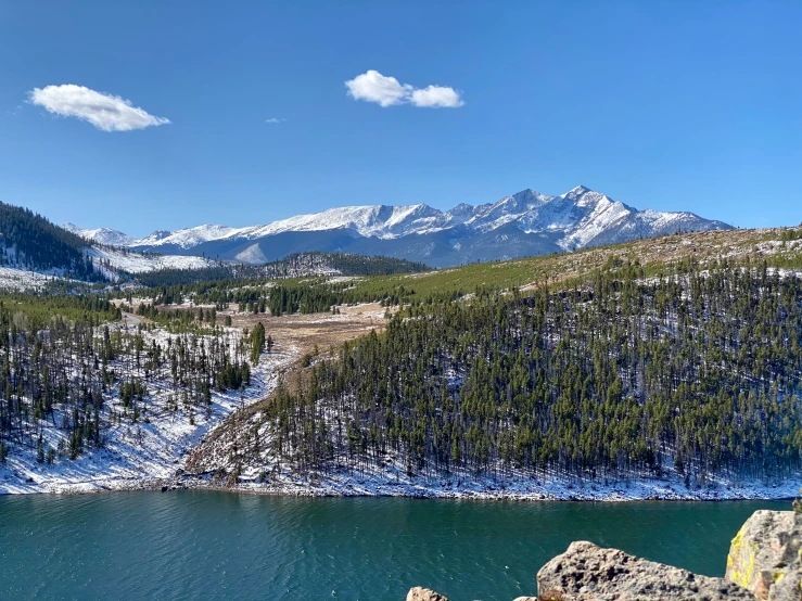 mountains, trees, and blue water fill the background