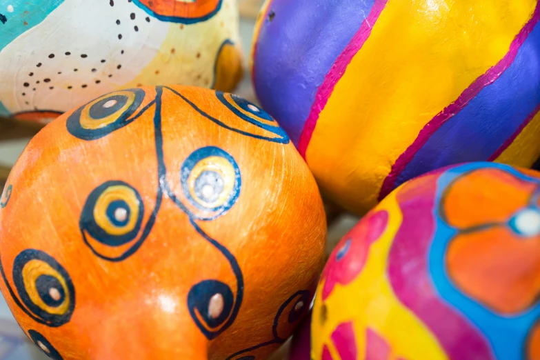 colorful painted eggs sitting on top of each other