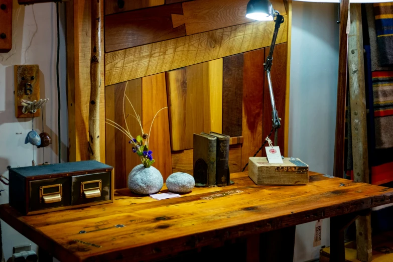 two vases with flowers are sitting on a wooden table