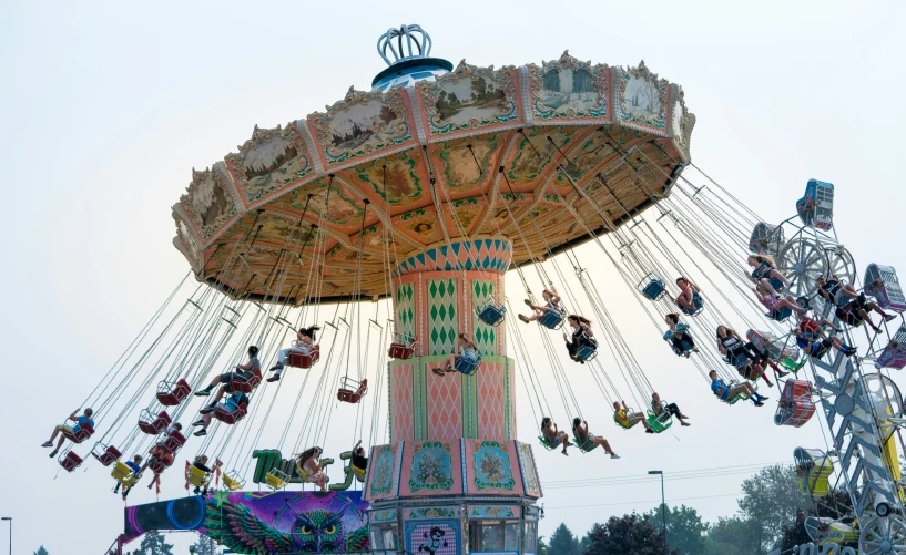 an old carnival ride with several people on it