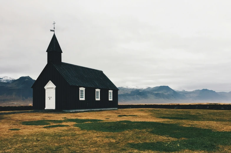 a church sits in the middle of a grassy area