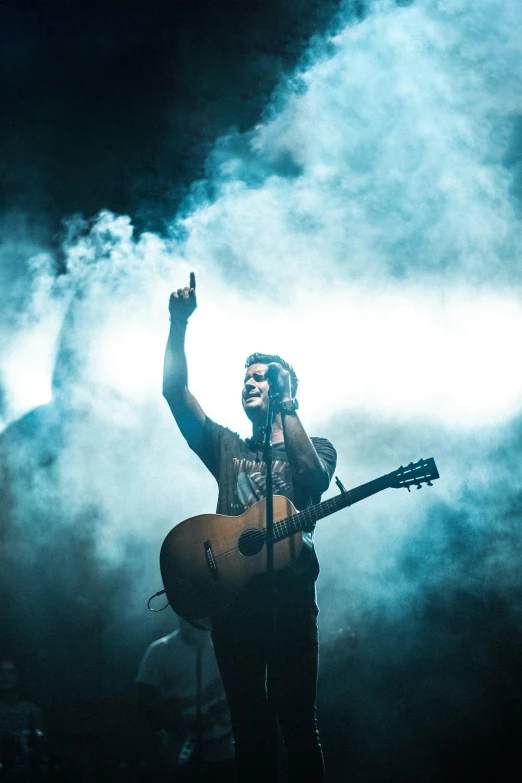 a man with dreadlocks is holding a guitar