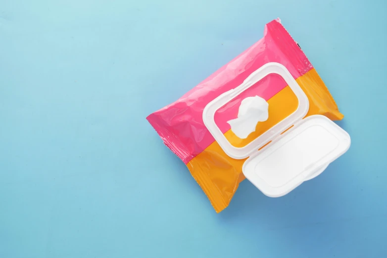 a colorful and white snack bag laying flat on a blue background