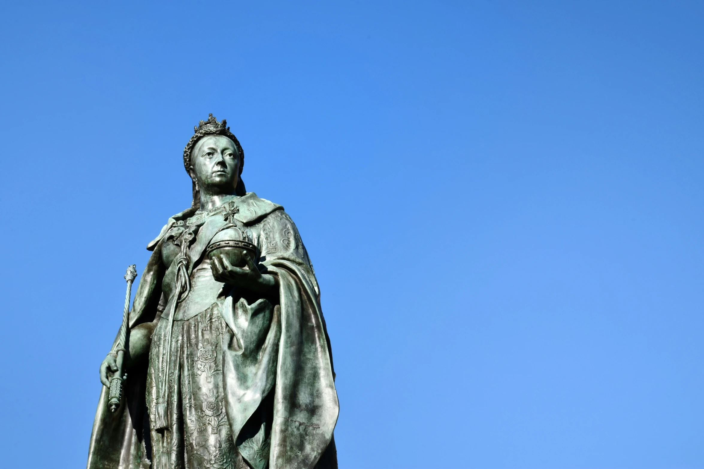 a statue of a queen atop a hill