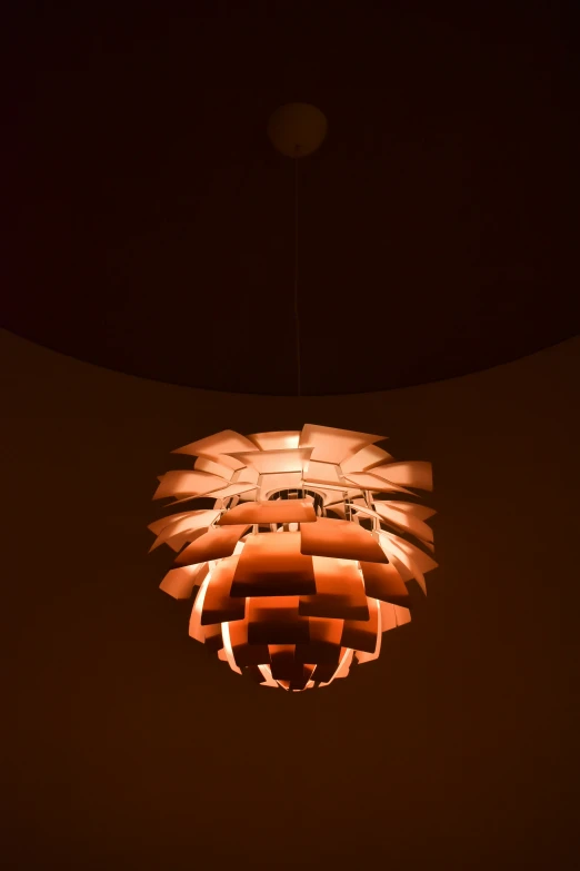 a lamp hanging on the wall in the dark