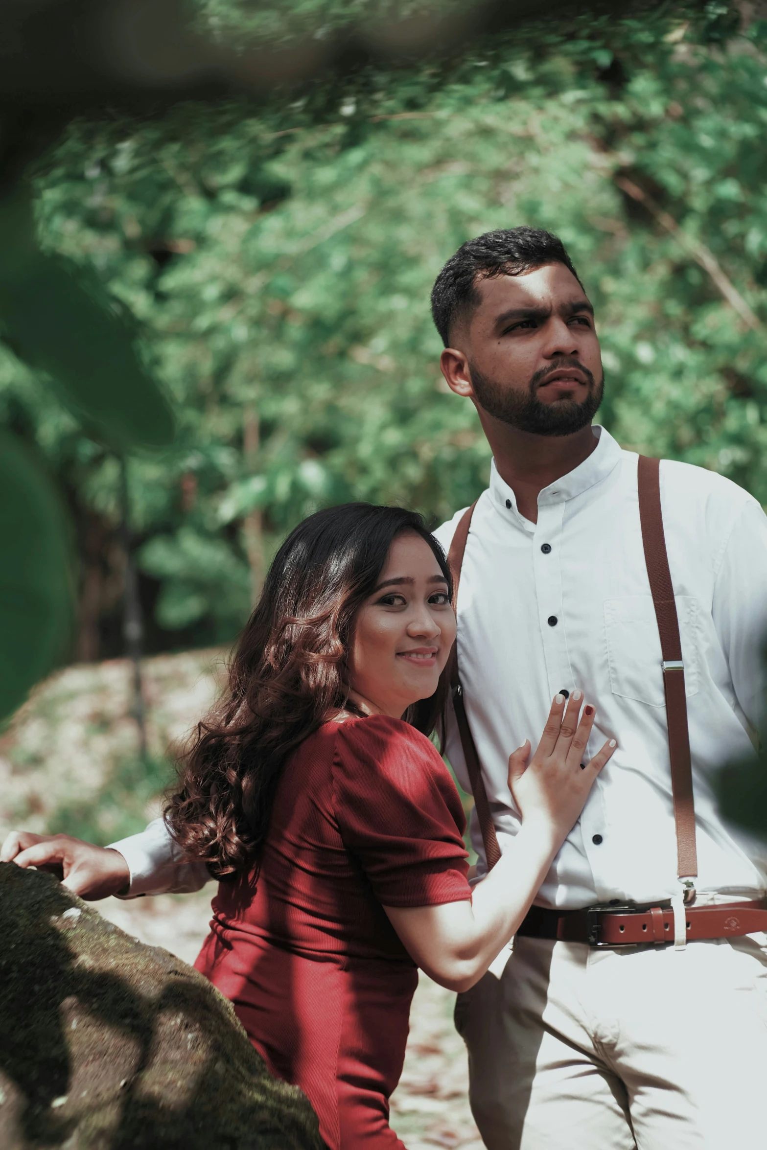 man standing between woman holding his hand close