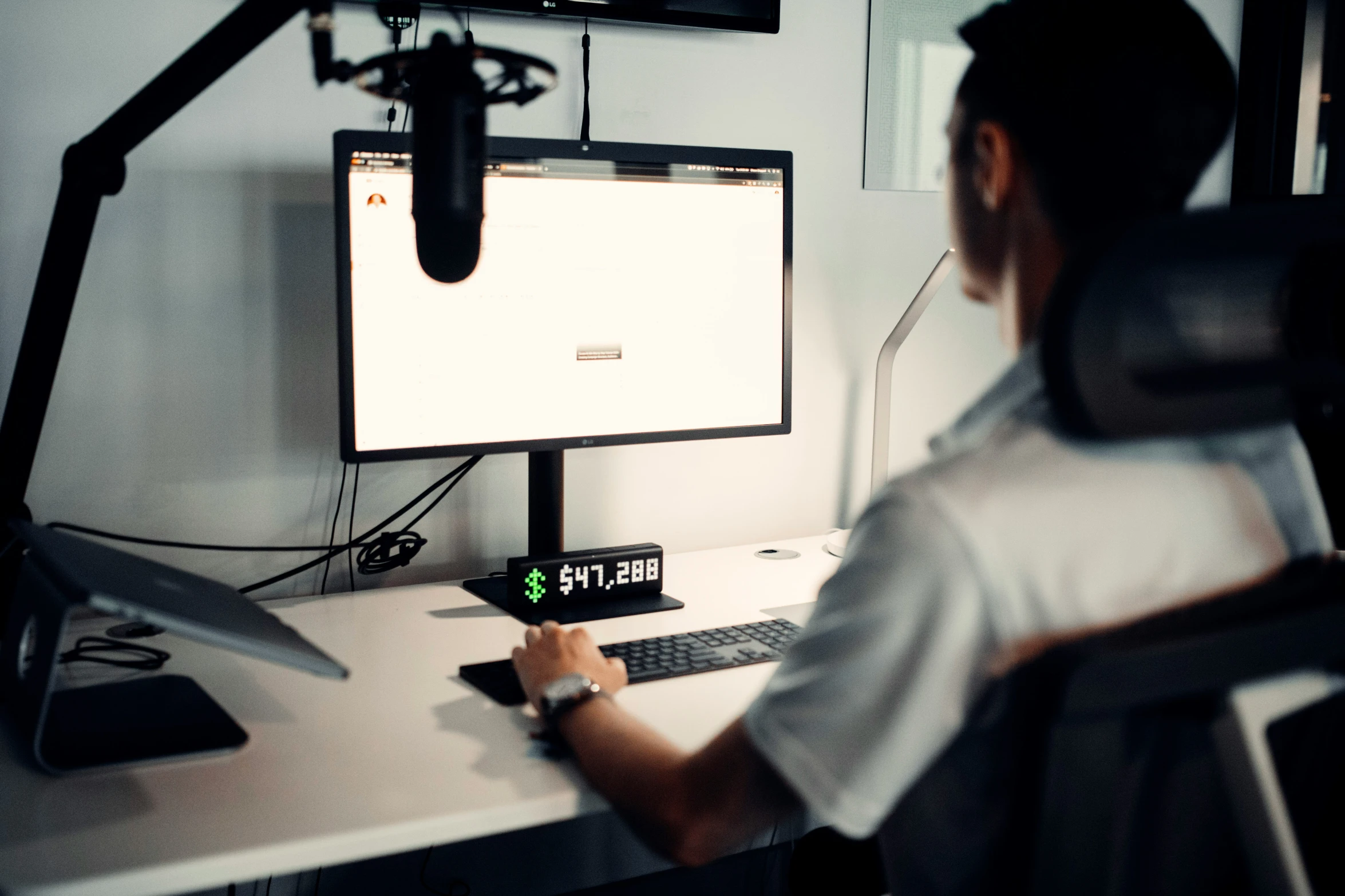 a person at a desk with an office chair in front of a computer