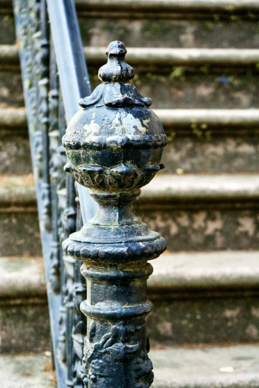 a metal fence and a hand rail on a stairway