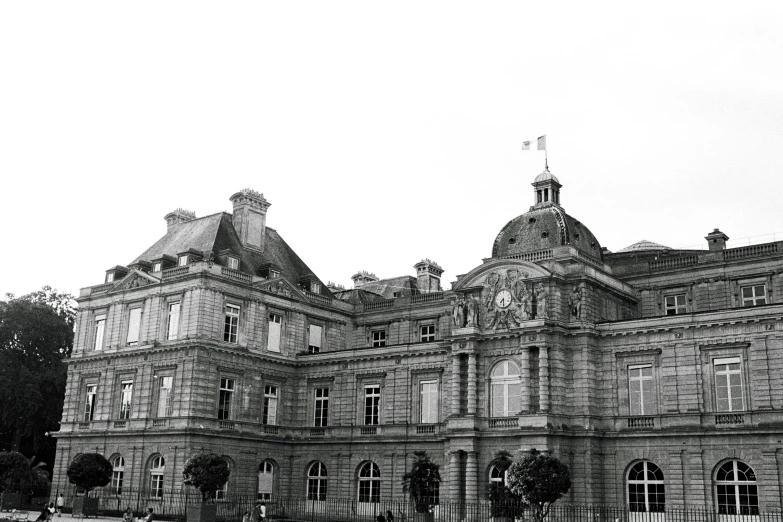 an old building with lots of windows and a clock on top