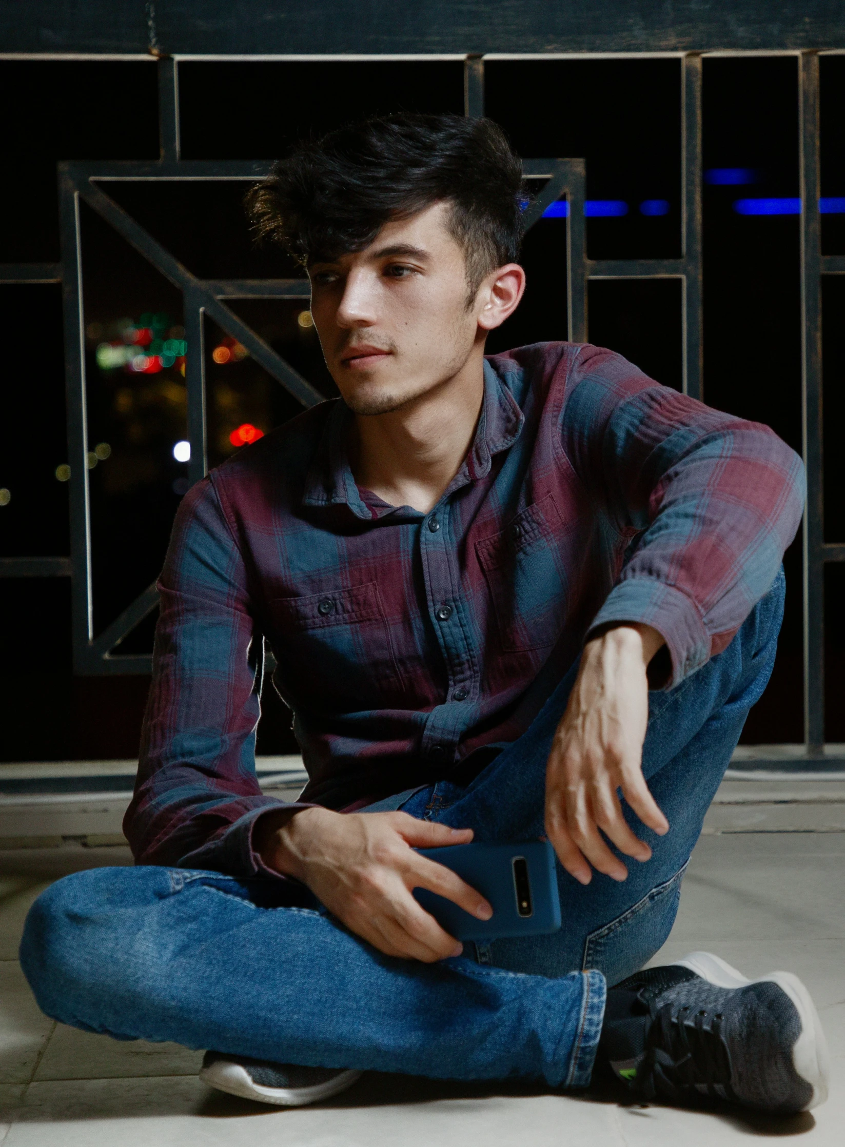 man posing for the camera while wearing blue jeans