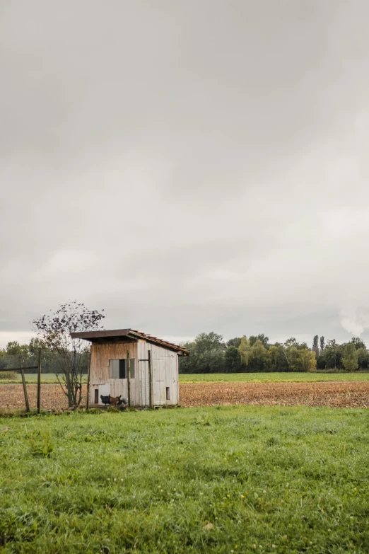 a small house in the middle of a field