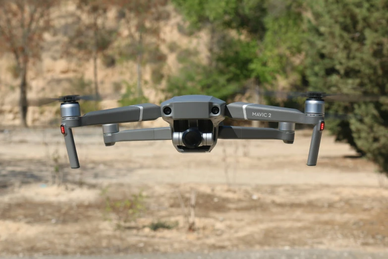 a camera attached to the front of a black quad with red and white ons