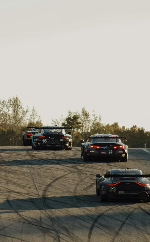 some cars are on a track driving together