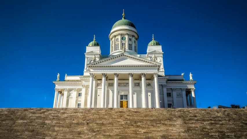 large stone structure with two green domes on top