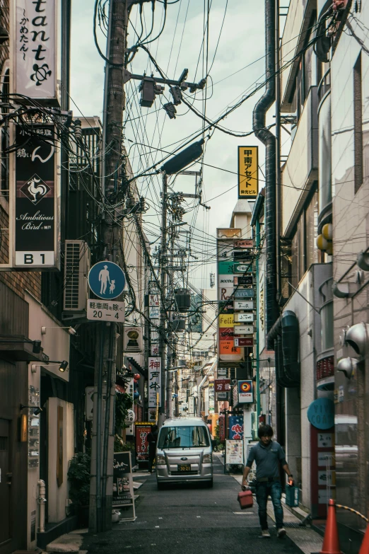 a man is walking down a small city street