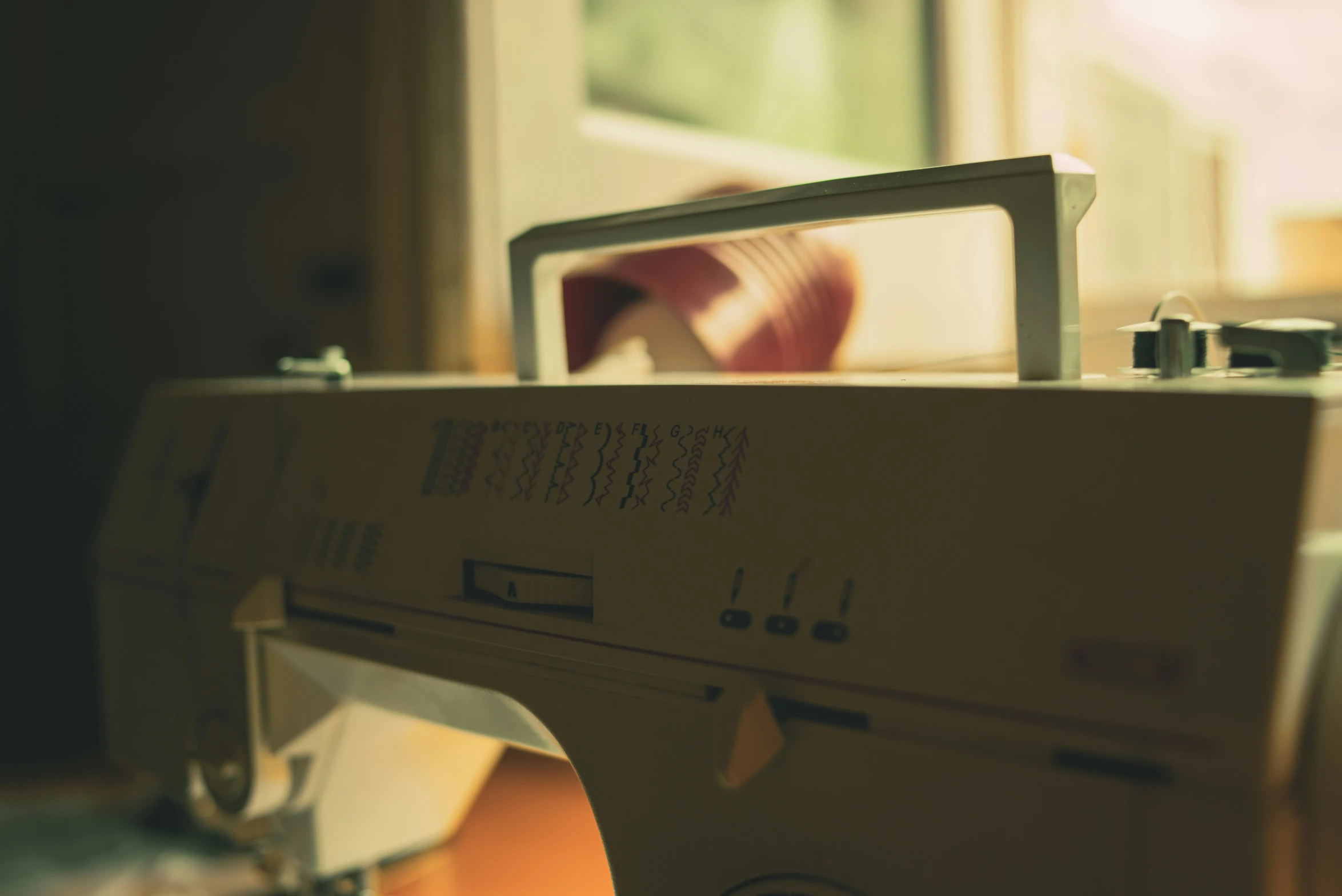 a sewing machine sits on a desk in a living room