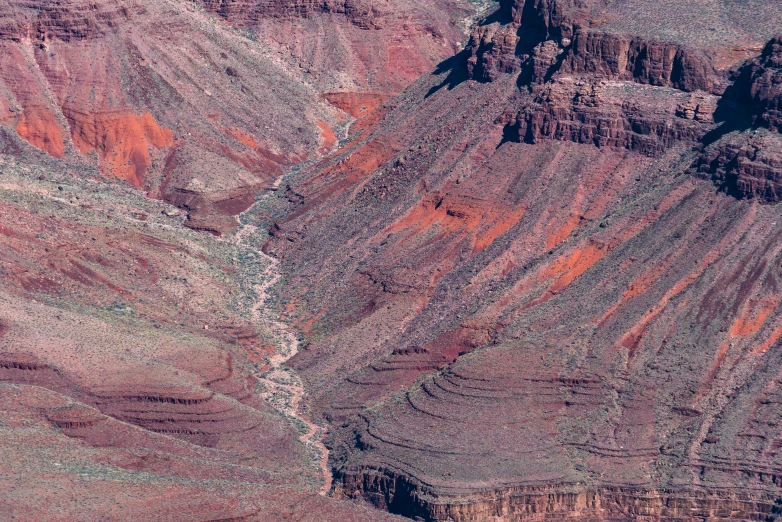 a mountain side view of a valley and some cliffs