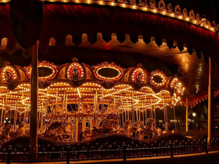 lights shining on an amut park carousel