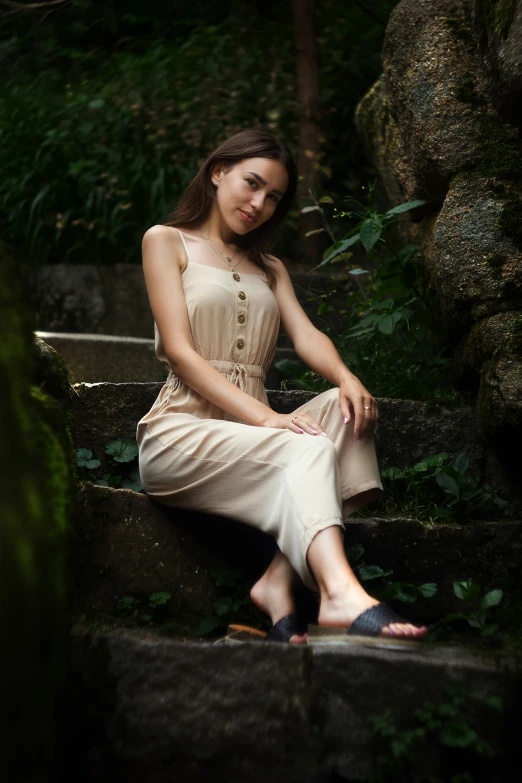 a young woman is sitting down on a set of stairs