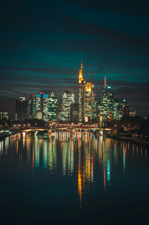 a large city at night with skyscrs and water