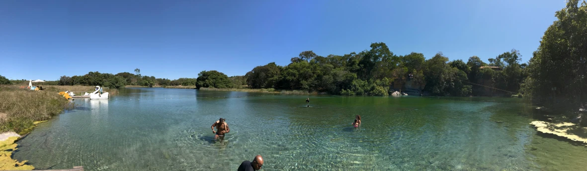 people playing in a shallow river while standing in the water