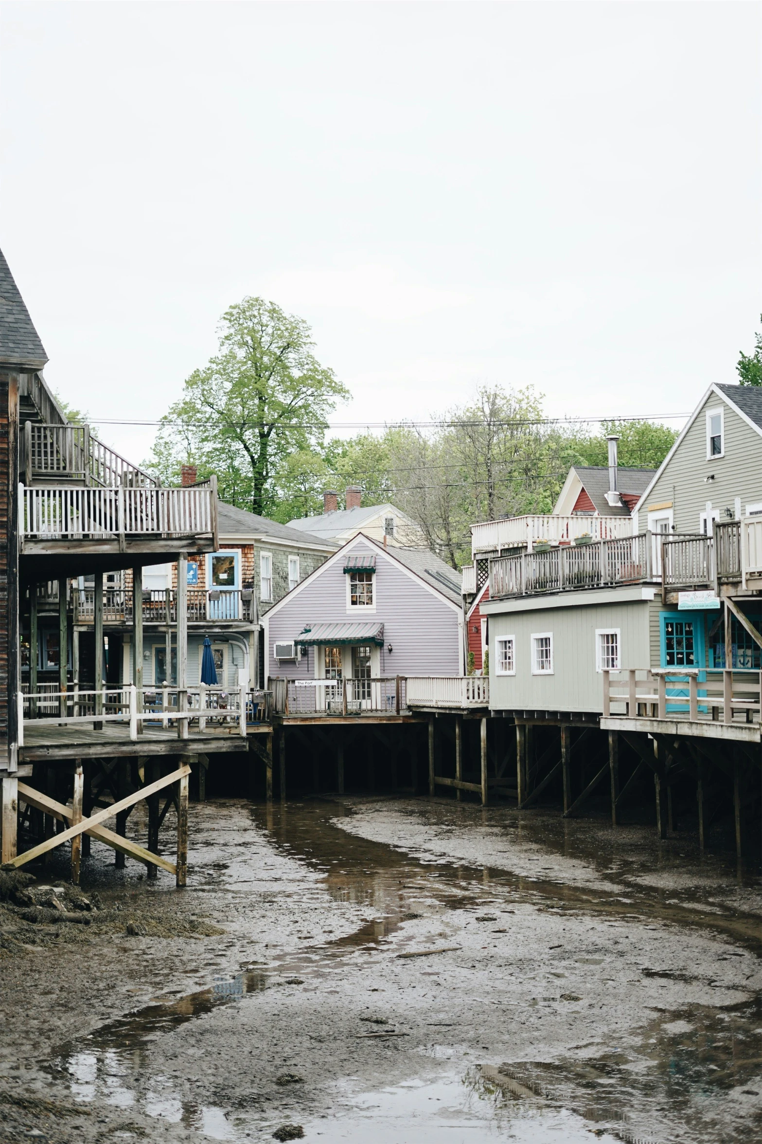 several houses on stilts on water and trees