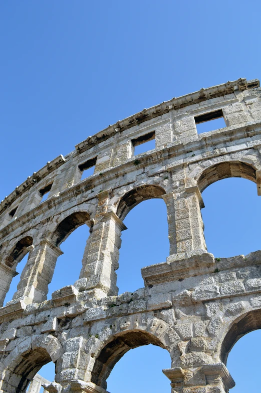 looking up at the arched windows of a roman aqueduct