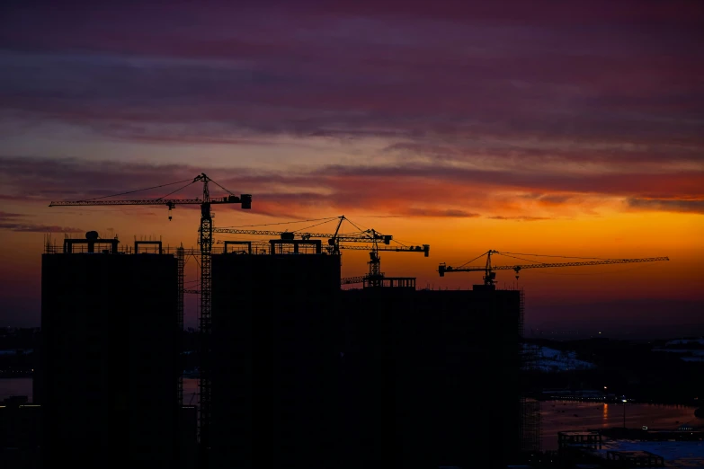 a building under construction with a sunset in the background