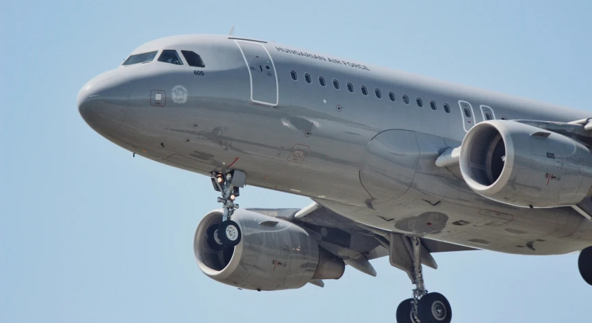 an airplane flying in the air during a sunny day