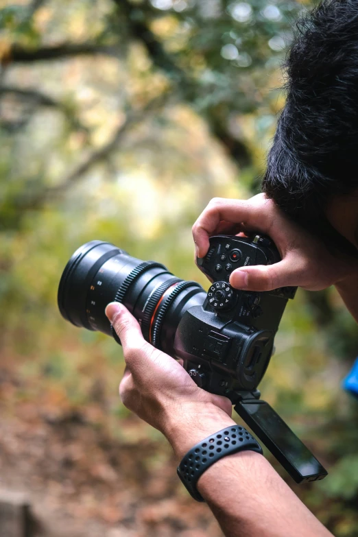 the person is holding a camera to take a po