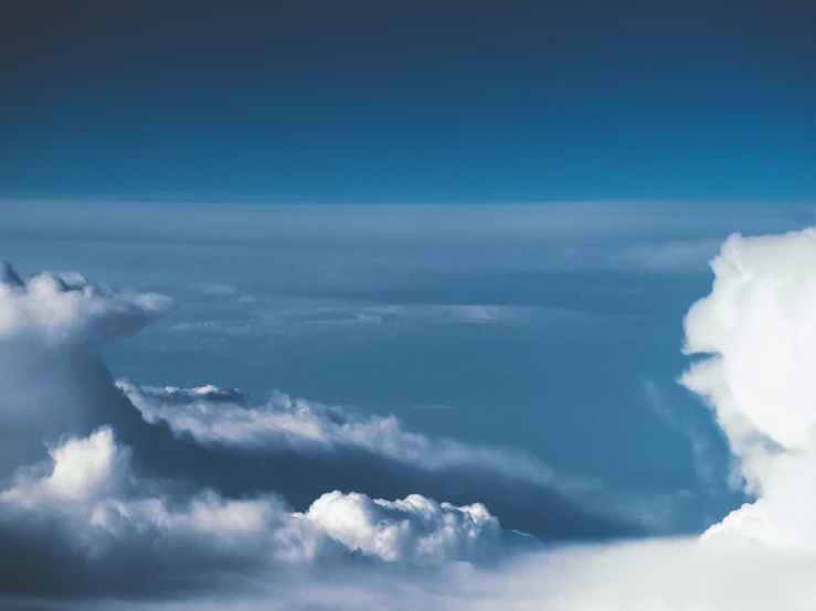 a blue sky and clouds seen from an airplane