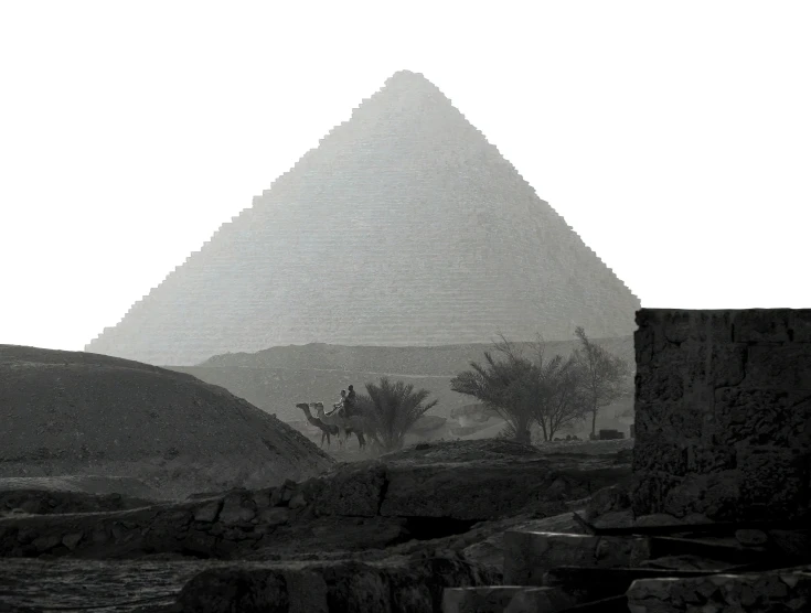 a person is walking near the pyramid in the rain