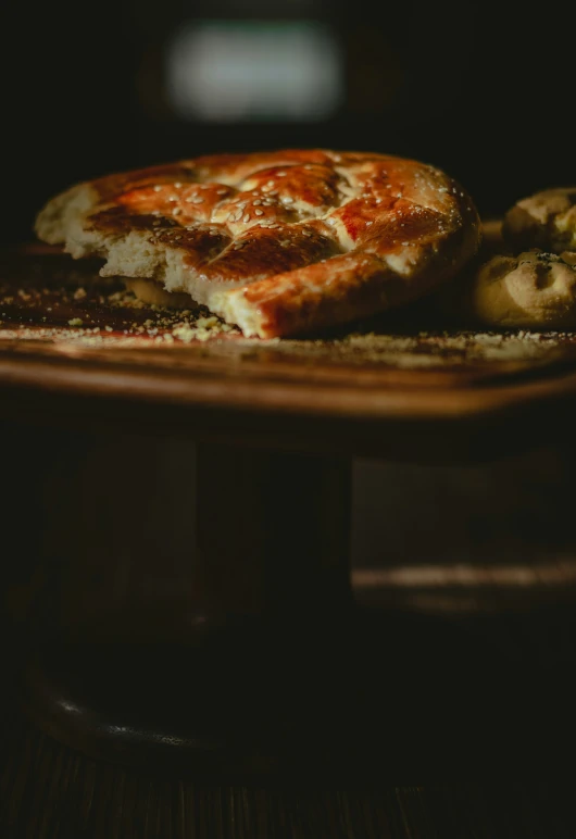 a pizza and some fruits on a small table