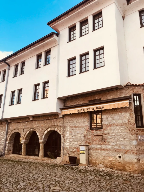 large building with several arched windows on stone floors