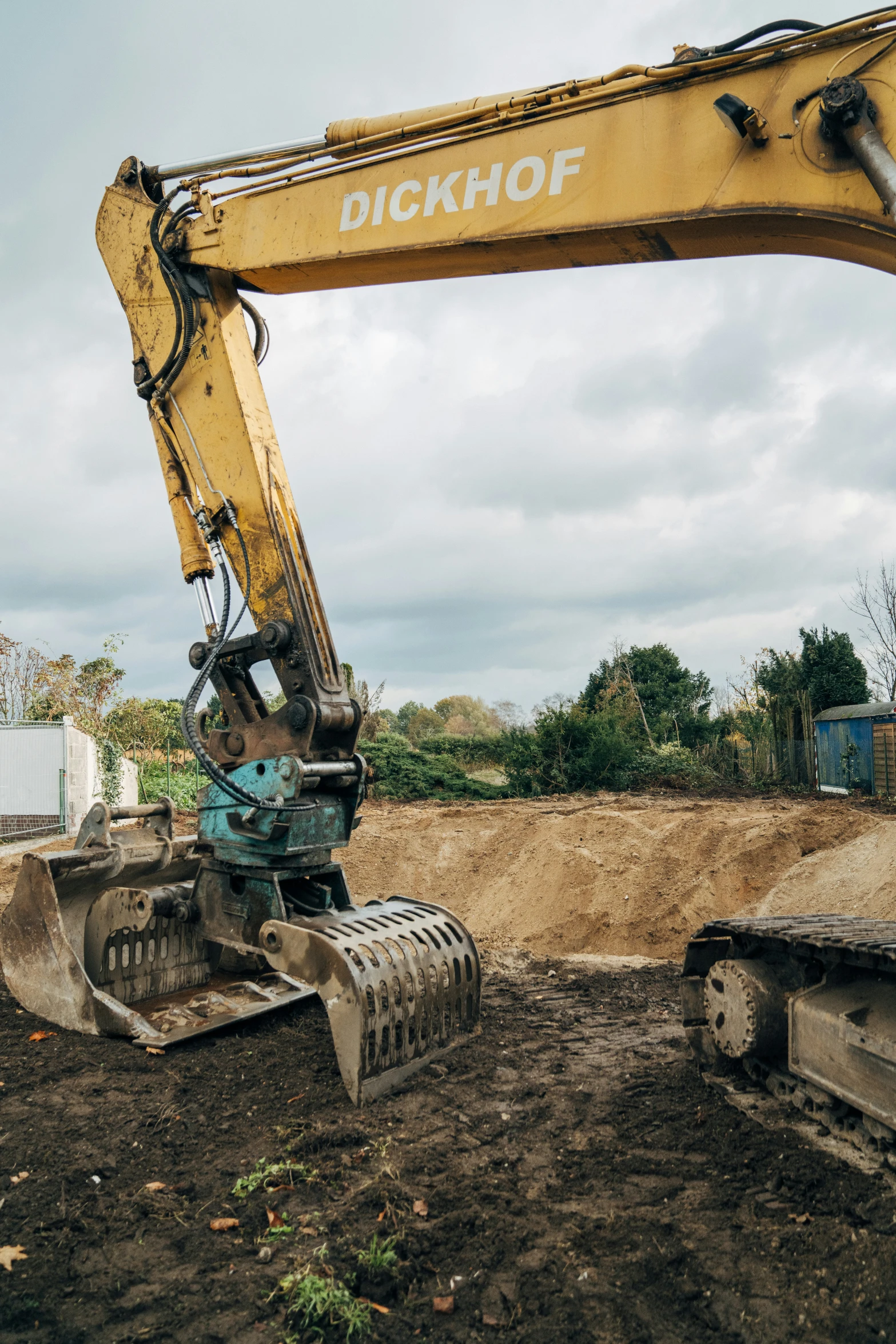 an older backhoe has been removed by a bulldozer