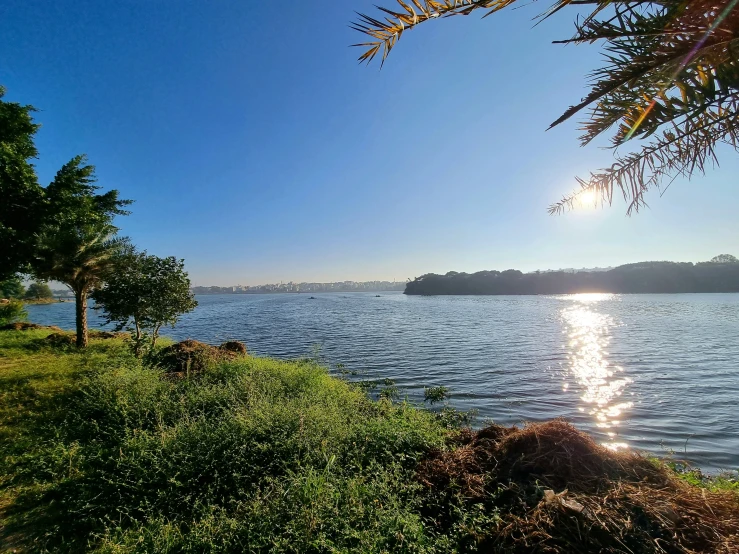 a lake view with the sun shining on it