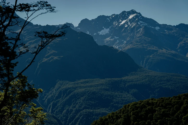 mountains and valleys with trees surrounding them