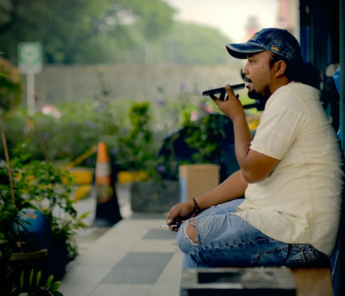 a man sitting on a bench with a pipe in his mouth