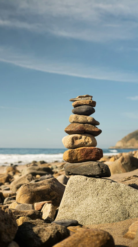 stacked rocks with an ocean in the background