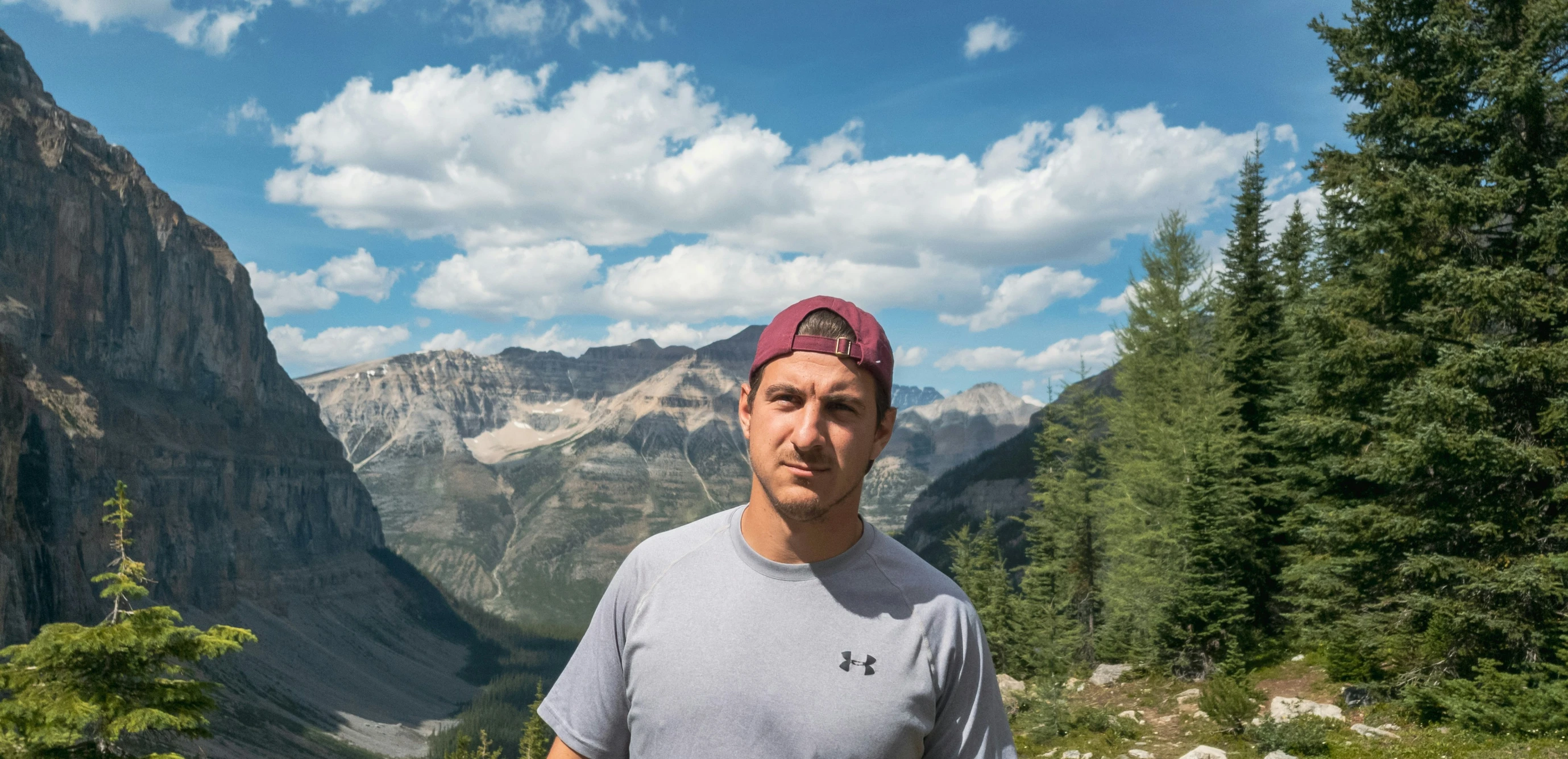 a man in a cap standing in a valley