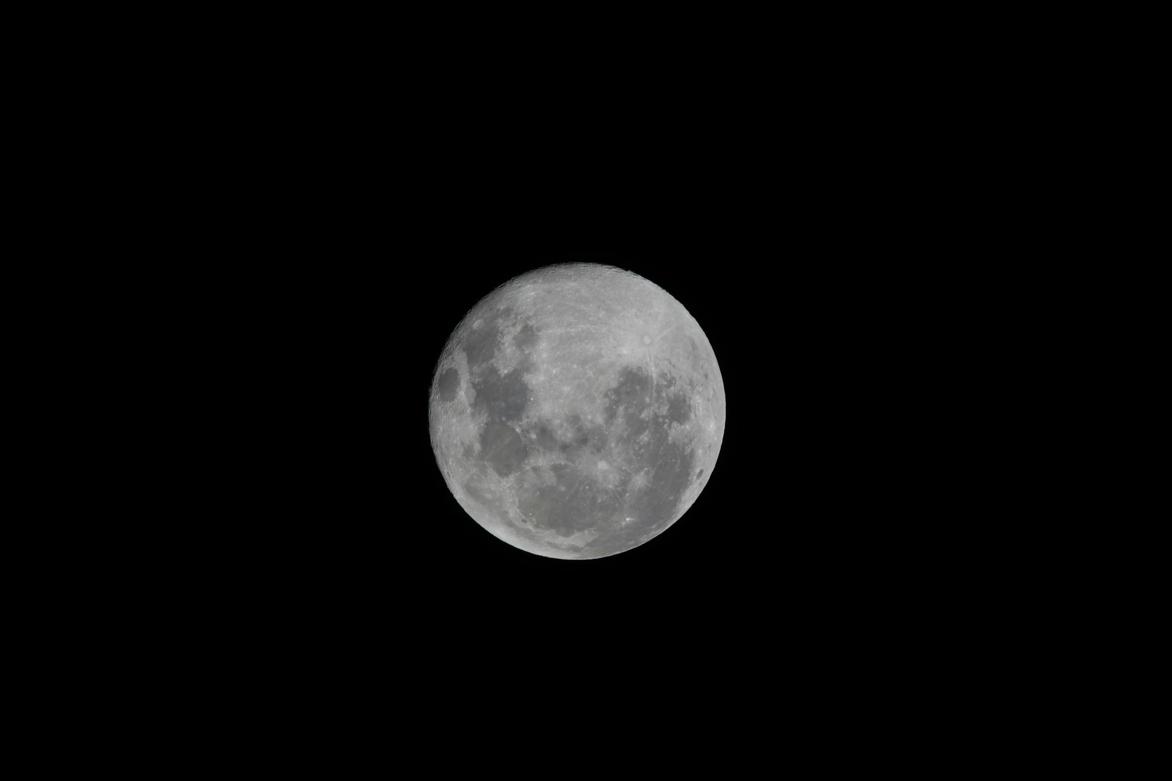 the moon in the dark sky is a black background