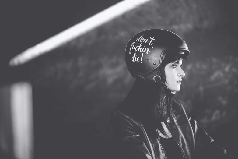 black and white pograph of a young woman wearing a helmet