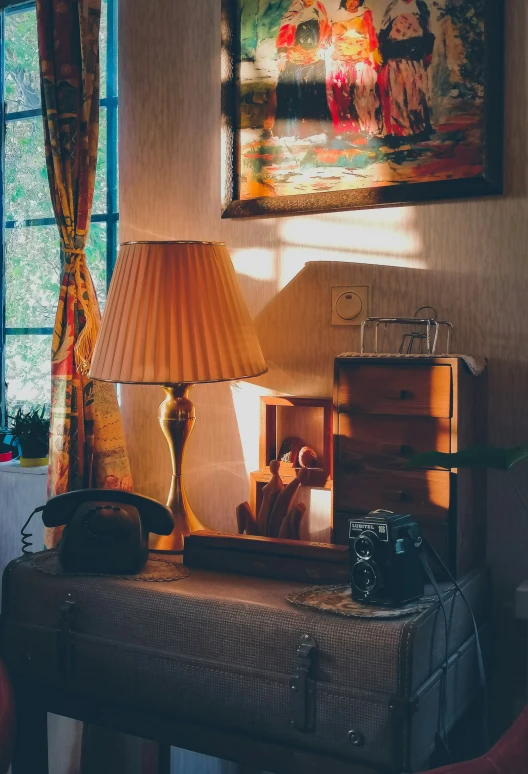 a lamp is on a table with suitcases near it