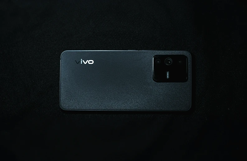 an open cell phone on a black surface