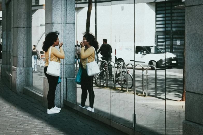 people are standing in front of a building with some bikes