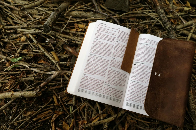 the open bible on brown leather cover with handwritten instructions