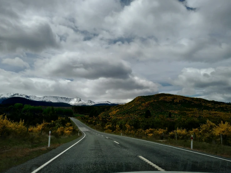 there is a highway with mountains in the background