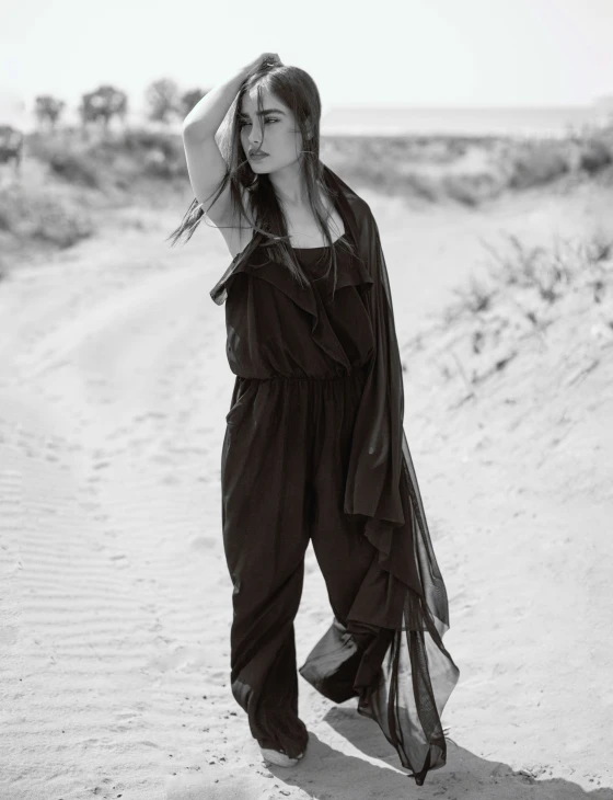 woman in black outfit on a desert road