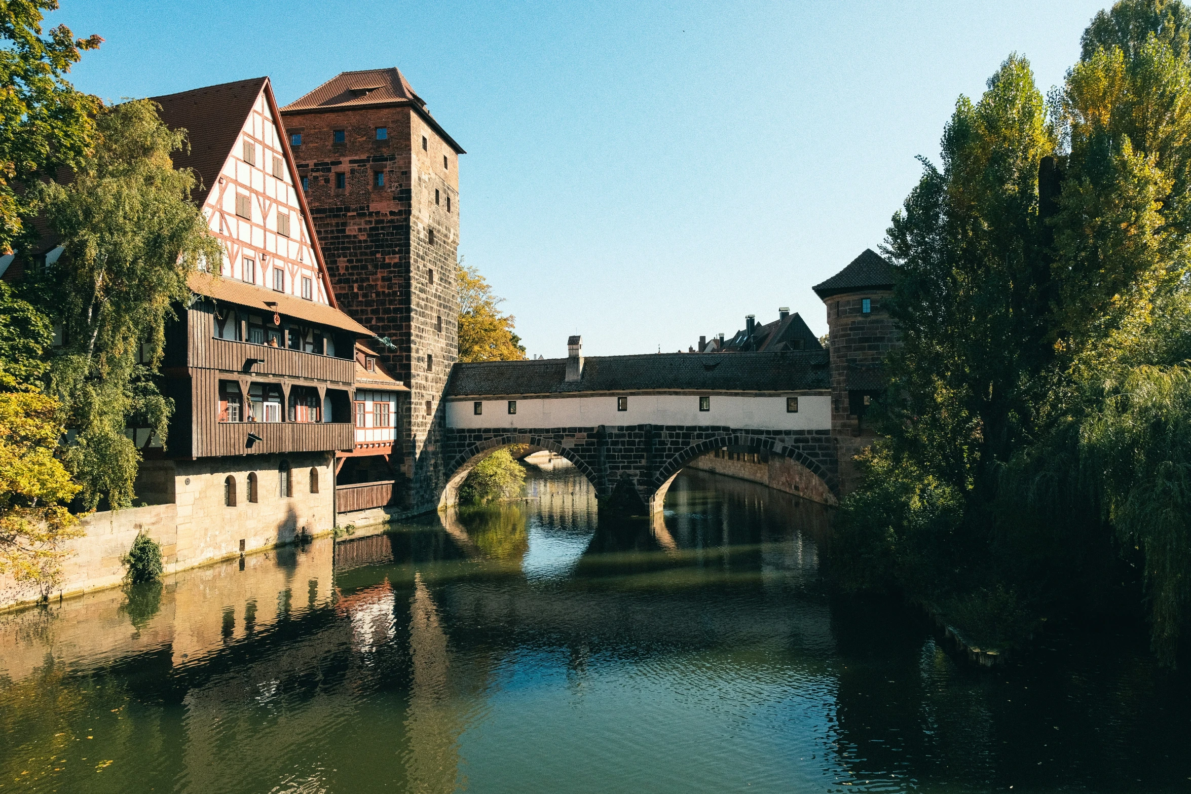 a river and houses by the edge of a street