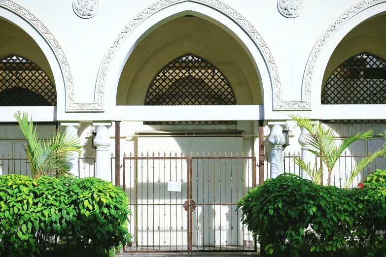 the door to an arched building with metal doors